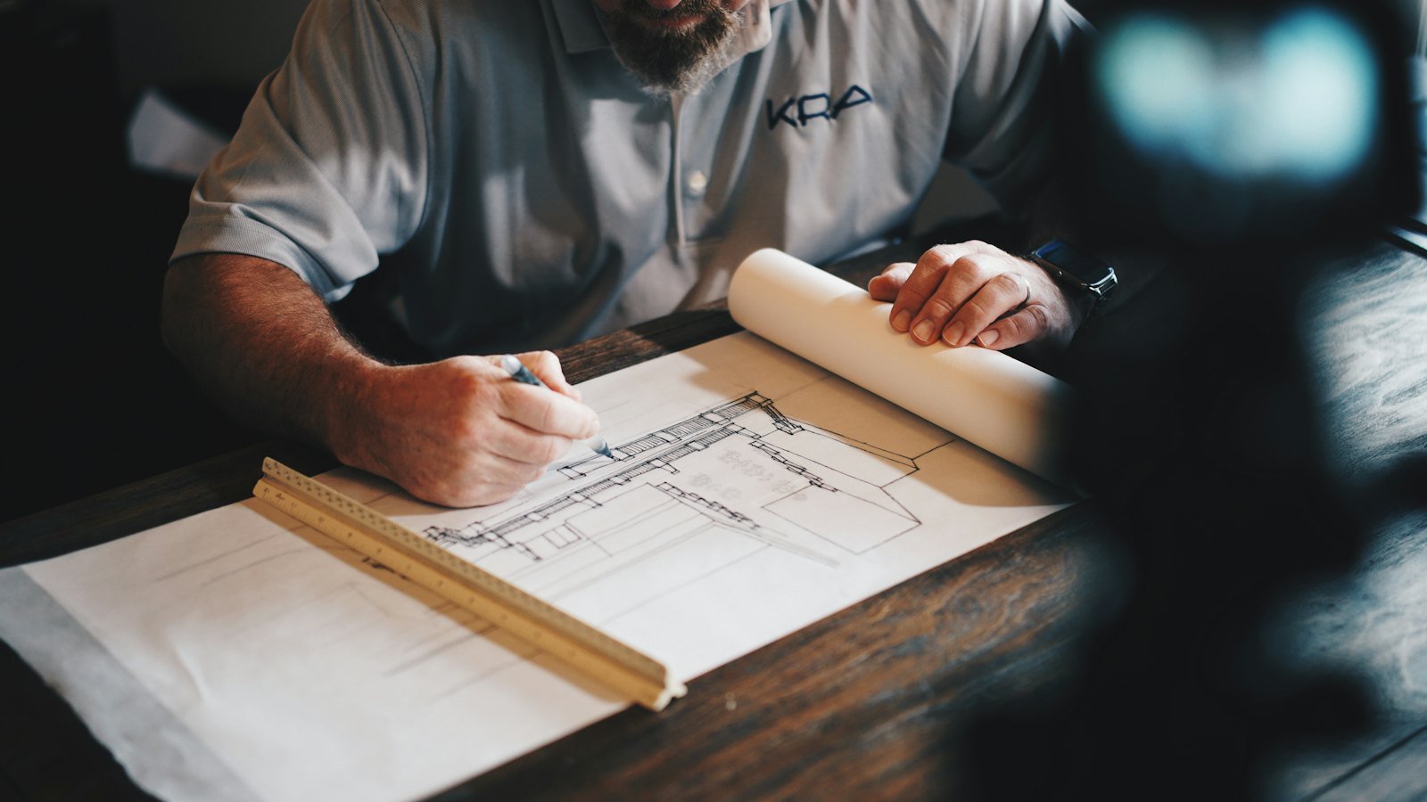 Construction manager marking up architectural drawings